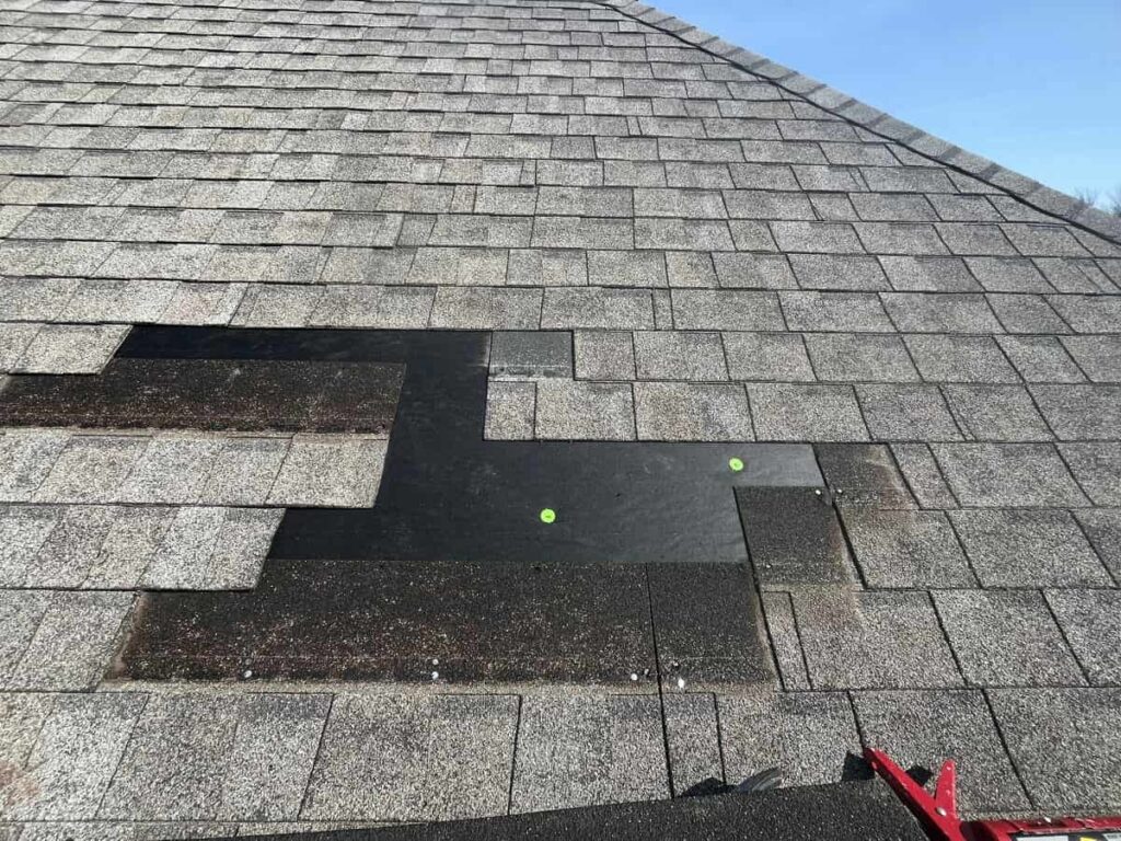 Roofer repairing a leaking roof on a home in Breckenridge, MN